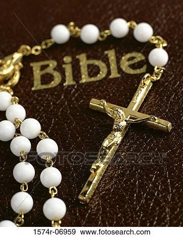 Prayer beads on a bible View Large Photo Image Stock Photo - Prayer beads on a bible. Fotosearch