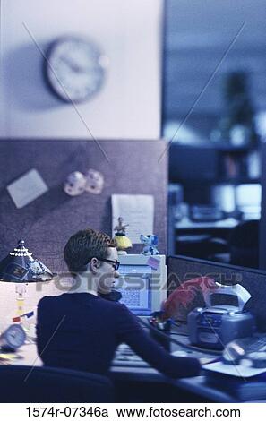 Stock Image - Rear view of a businesswoman talking on a telephone. Fotosearch