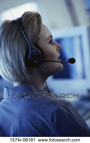Stock Image - Rear view of a customer service representative wearing a headset. Fotosearch