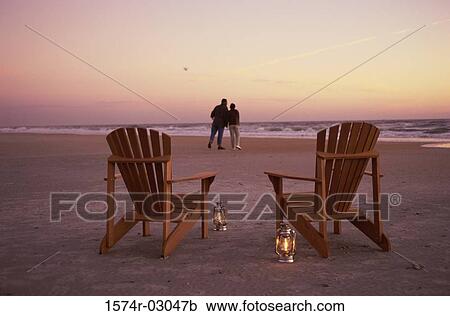 Rear view of a young couple walking on the beach View Large Photo Image Stock Image - Rear view of a young couple walking on the beach. Fotosearch