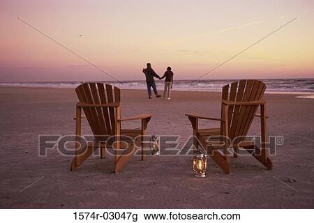 Rear view of a young couple walking on the beach View Large Photo Image Stock Image - Rear view of a young couple walking on the beach. Fotosearch
