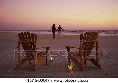 Rear view of a young couple walking on the beach View Large Photo Image Stock Image - Rear view of a young couple walking on the beach. Fotosearch