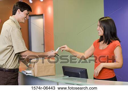 Receptionist receiving a receipt from a delivery man View Large Photo Image Stock Image - Receptionist receiving a receipt from a delivery man. Fotosearch