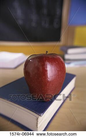 Red apple on a book View Large Photo Image Picture - Red apple on a book. Fotosearch