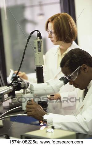 Researchers working with a microscope View Large Photo Image Stock Image - Researchers working with a microscope. Fotosearch
