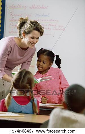 School children in a classroom with a female teacher View Large Photo Image Stock Photo - School children in a classroom with a female teacher. Fotosearch