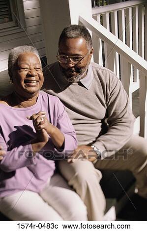 Senior couple sitting together on the stairs View Large Photo Image Stock Image - Senior couple sitting together on the stairs. Fotosearch