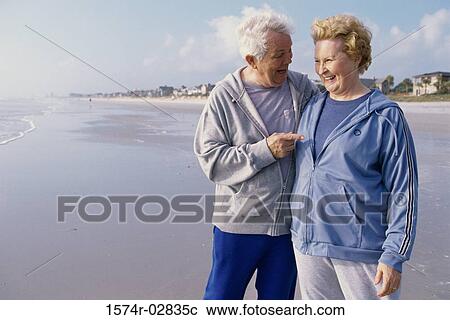 Senior couple standing on the beach View Large Photo Image Stock Image - Senior couple standing on the beach. Fotosearch