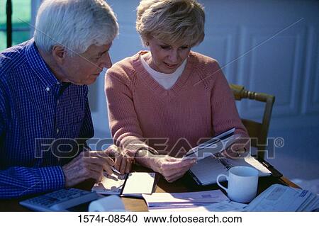 Senior couple writing a check View Large Photo Image Stock Image - Senior couple writing a check. Fotosearch