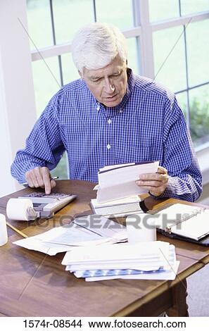 Senior man calculating bills View Large Photo Image Picture - Senior man calculating bills. Fotosearch