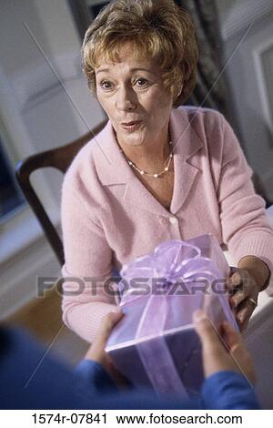 Senior woman receiving a gift View Large Photo Image Stock Image - Senior woman receiving a gift. Fotosearch