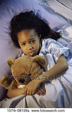 Stock Image - Sick girl lying in bed. Fotosearch