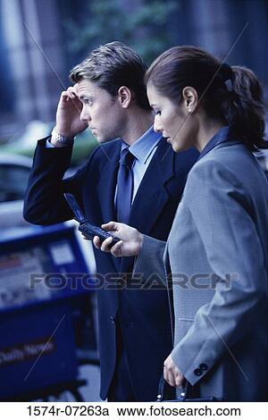 Stock Image - Side profile of a businessman and a businesswoman. Fotosearch