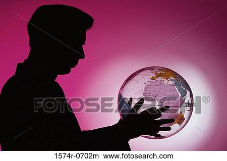 Picture - Side profile of a businessman holding a globe. Fotosearch