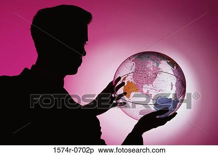 Stock Photography - Side profile of a businessman holding a globe. Fotosearch