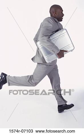 Side profile of a businessman running with a briefcase View Large Photo Image Stock Image - Side profile of a businessman running with a briefcase. Fotosearch
