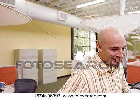 Side profile of a businessman smiling in an office View Large Photo Image Stock Image - Side profile of a businessman smiling in an office. Fotosearch