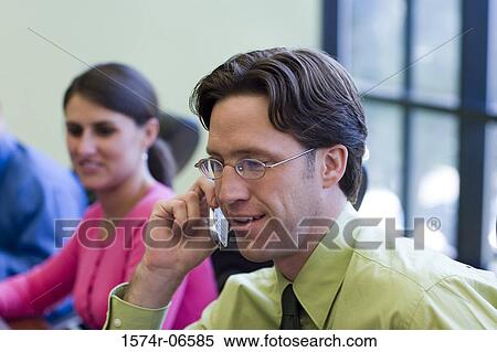 Side profile of a businessman talking on a mobile phone in a conference room View Large Photo Image Stock Photography - Side profile of a businessman talking on a mobile phone in a conference room. Fotosearch
