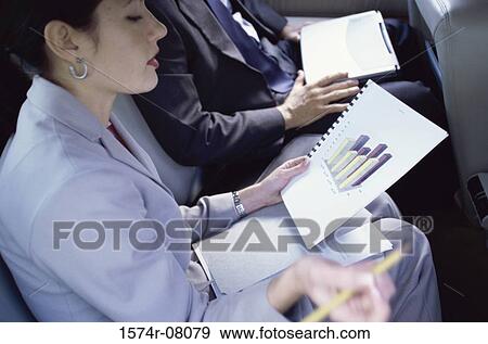 Side profile of a businesswoman holding documents View Large Photo Image Stock Photo - Side profile of a businesswoman holding documents. Fotosearch