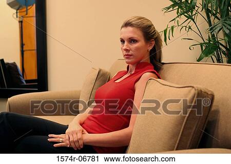 Side profile of a businesswoman sitting on a couch View Large Photo Image Stock Image - Side profile of a businesswoman sitting on a couch. Fotosearch