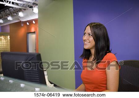 Side profile of a businesswoman sitting in front of a computer View Large Photo Image Stock Photo - Side profile of a businesswoman sitting in front of a computer. Fotosearch