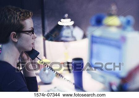 Side profile of a businesswoman talking on a telephone View Large Photo Image Picture - Side profile of a businesswoman talking on a telephone. Fotosearch