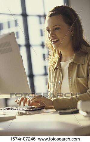 Side profile of a businesswoman using a computer View Large Photo Image Stock Photograph - Side profile of a businesswoman using a computer. Fotosearch