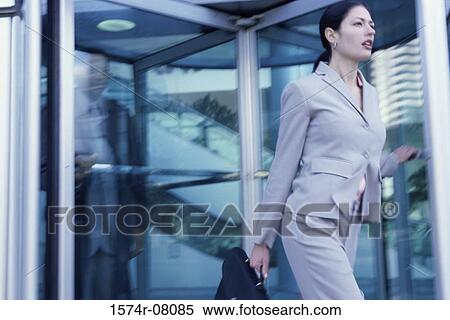 Stock Photography - Side profile of a businesswoman walking. Fotosearch