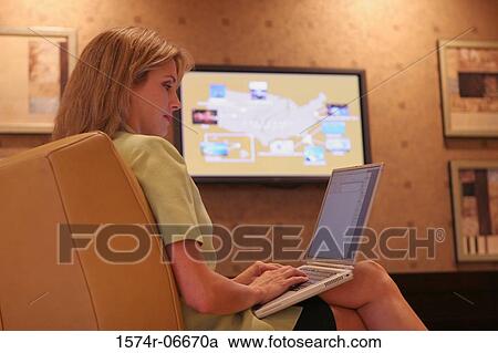Side profile of a businesswoman working on a laptop View Large Photo Image Stock Image - Side profile of a businesswoman working on a laptop. Fotosearch