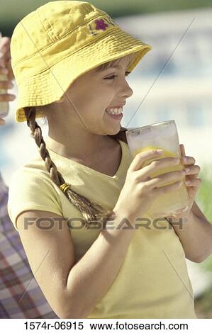 Side profile of a girl holding a glass of lemonade View Large Photo Image Stock Photography - Side profile of a girl holding a glass of lemonade. Fotosearch