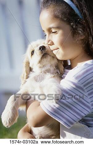 Side profile of a girl holding her puppy View Large Photo Image Stock Image - Side profile of a girl holding her puppy. Fotosearch