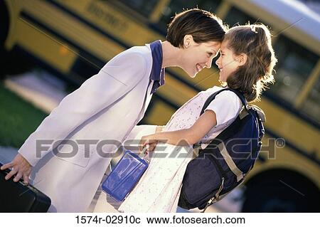 Side profile of a mother and her daughter looking at each other View Large Photo Image Stock Image - Side profile of a mother and her daughter looking at each other. Fotosearch