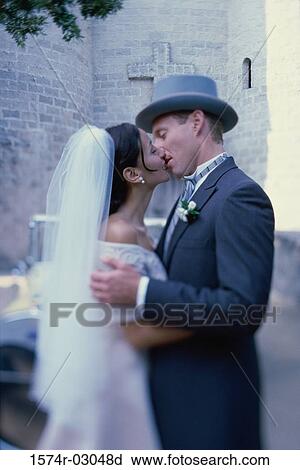 Side profile of a newlywed couple kissing each other View Large Photo Image Stock Image - Side profile of a newlywed couple kissing each other. Fotosearch