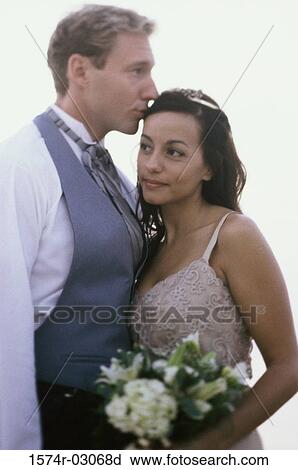 Side profile of a young couple embracing View Large Photo Image Stock Image - Side profile of a young couple embracing. Fotosearch