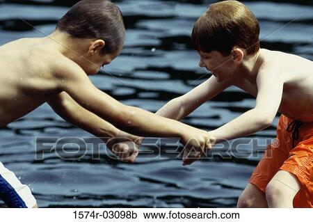 Side profile of two boys playing in the water View Large Photo Image Stock Image - Side profile of two boys playing in the water. Fotosearch