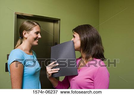Side profile of two businesswomen standing near an elevator View Large Photo Image Stock Photo - Side profile of two businesswomen standing near an elevator. Fotosearch