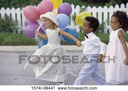 Side profile of two girls and a boy walking together holding hands View Large Photo Image Stock Image - Side profile of two girls and a boy walking together holding hands. Fotosearch