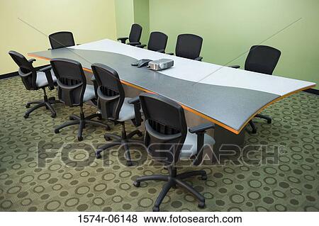 Stock Photo - Slide projector and a conference phone on the table in a boardroom. Fotosearch