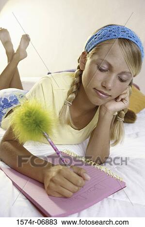 Teenage girl writing in a notebook View Large Photo Image Stock Image - Teenage girl writing in a notebook. Fotosearch