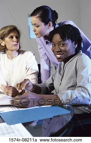 Three businesswomen discussing in an office View Large Photo Image Stock Image - Three businesswomen discussing in an office. Fotosearch