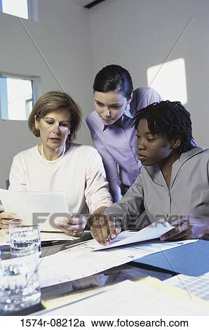 Three businesswomen discussing in an office View Large Photo Image Stock Image - Three businesswomen discussing in an office. Fotosearch
