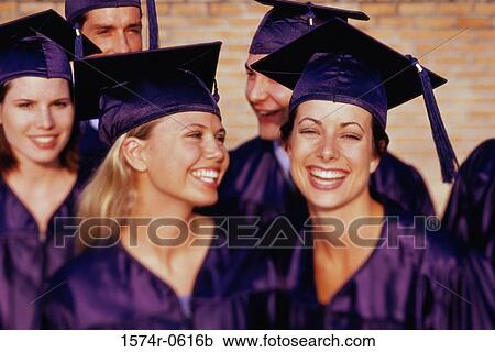 Stock Image - Three female graduates and two male graduates smiling. Fotosearch