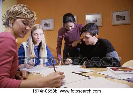 Stock Image - Three teenage girls and a teenage boy studying together. Fotosearch