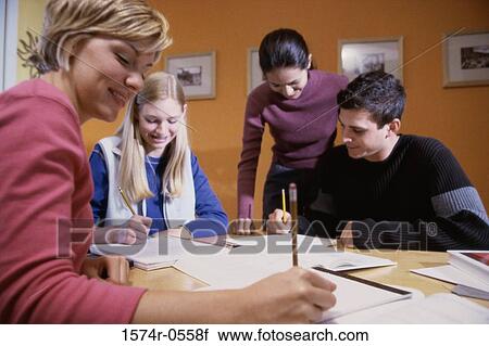 Three teenage girls and a teenage boy studying together View Large Photo Image Stock Image - Three teenage girls and a teenage boy studying together. Fotosearch