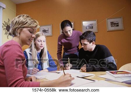 Three teenage girls and a teenage boy studying together View Large Photo Image Stock Image - Three teenage girls and a teenage boy studying together. Fotosearch
