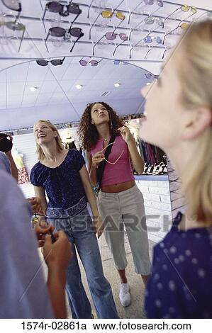 Three young women shopping for sunglasses View Large Photo Image Stock Image - Three young women shopping for sunglasses. Fotosearch
