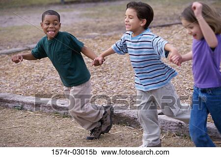 Two boys and a girl running holding hands View Large Photo Image Stock Image - Two boys and a girl running holding hands. Fotosearch
