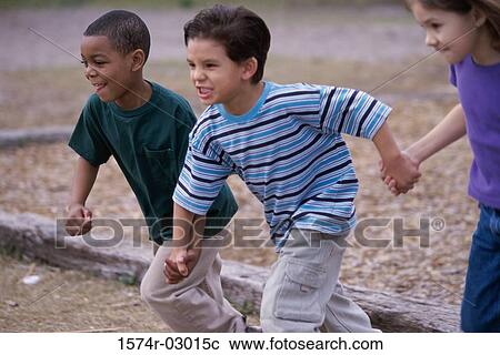 Two boys and a girl running holding hands View Large Photo Image Stock Image - Two boys and a girl running holding hands. Fotosearch