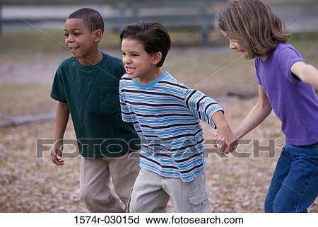 Two boys and a girl running holding hands View Large Photo Image Stock Image - Two boys and a girl running holding hands. Fotosearch