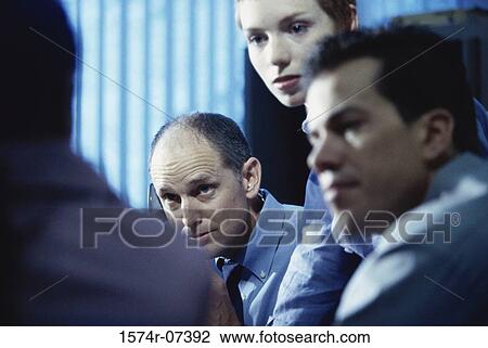 Two businessmen and a businesswoman in an office View Large Photo Image Stock Image - Two businessmen and a businesswoman in an office. Fotosearch